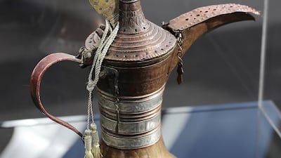 A dallah belonging to Sheikh Zayed in the early 20th century on display during the Majlis Zayed Exhibition in Abu Dhabi. The traditional coffee pot, a symbol of Emirati hospitality, appears on the Dh1 coin. Pawan Singh / The National