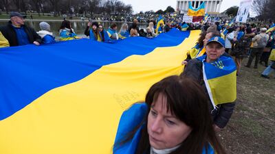 Ukrainians and their supporters carry a huge Ukrainian flag during a rally at the National Mall near the Lincoln Memorial in Washington. AP
