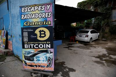 A 'Bitcoin accepted here' sign outside a car workshop in El Salvador. Reuters