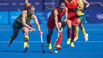 Jiaqi Zhong of China, centre, guards the ball from Australia's Kaitlin Nobbs in the women's quarter-final field hockey match at the Stade Yves du Manoir in Colombes, France, on August 5. EPA