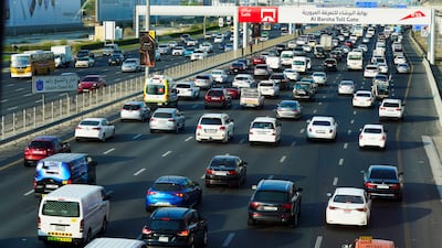Vehicles pass under a toll gate on Sheikh Zayed Road in Dubai on Monday, September 5, 2022. Toll gate operator Salik will make an initial public offering on the emirate's stock market, becoming the latest state-linked company to list. AP
