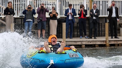 Mr Davey rides a towable inflatable during a visit to Lakeside Ski & Wake, in the Cotswolds. Reuters