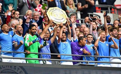 Manchester City's Sergio Aguero and David Silva celebrate winning the FA Community Shield with teammates. Reuters