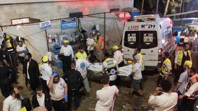 Israeli security officials and rescuers carry the body of a victim who died during a Lag BaOmer celebration at Mount Meron in northern Israel. AP Photo